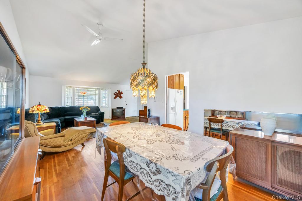 196 Haypath Road Old Bethpage, NY 11804 - Photo 7 of 21 Dining area with lofted ceiling, wood finished floors, and a ceiling fan