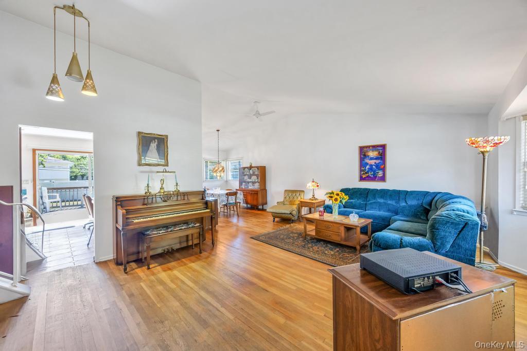 196 Haypath Road Old Bethpage, NY 11804 - Photo 10 of 21 Living area with vaulted ceiling and light wood finished floors
