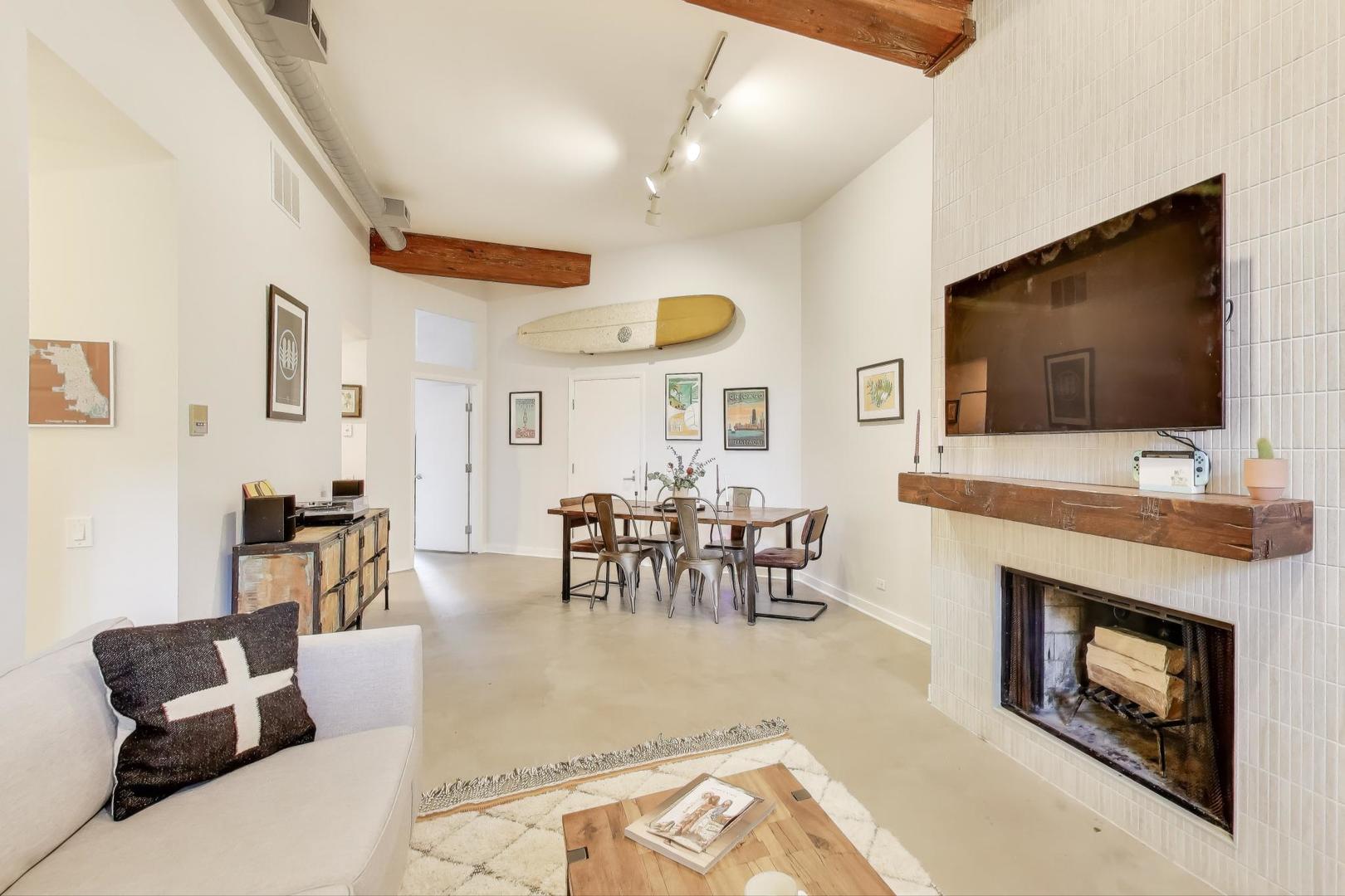 1323 West Belden Avenue, Unit E1 Chicago, IL 60614 - Photo 4 of 23 a living room with furniture a flat screen tv and a fireplace