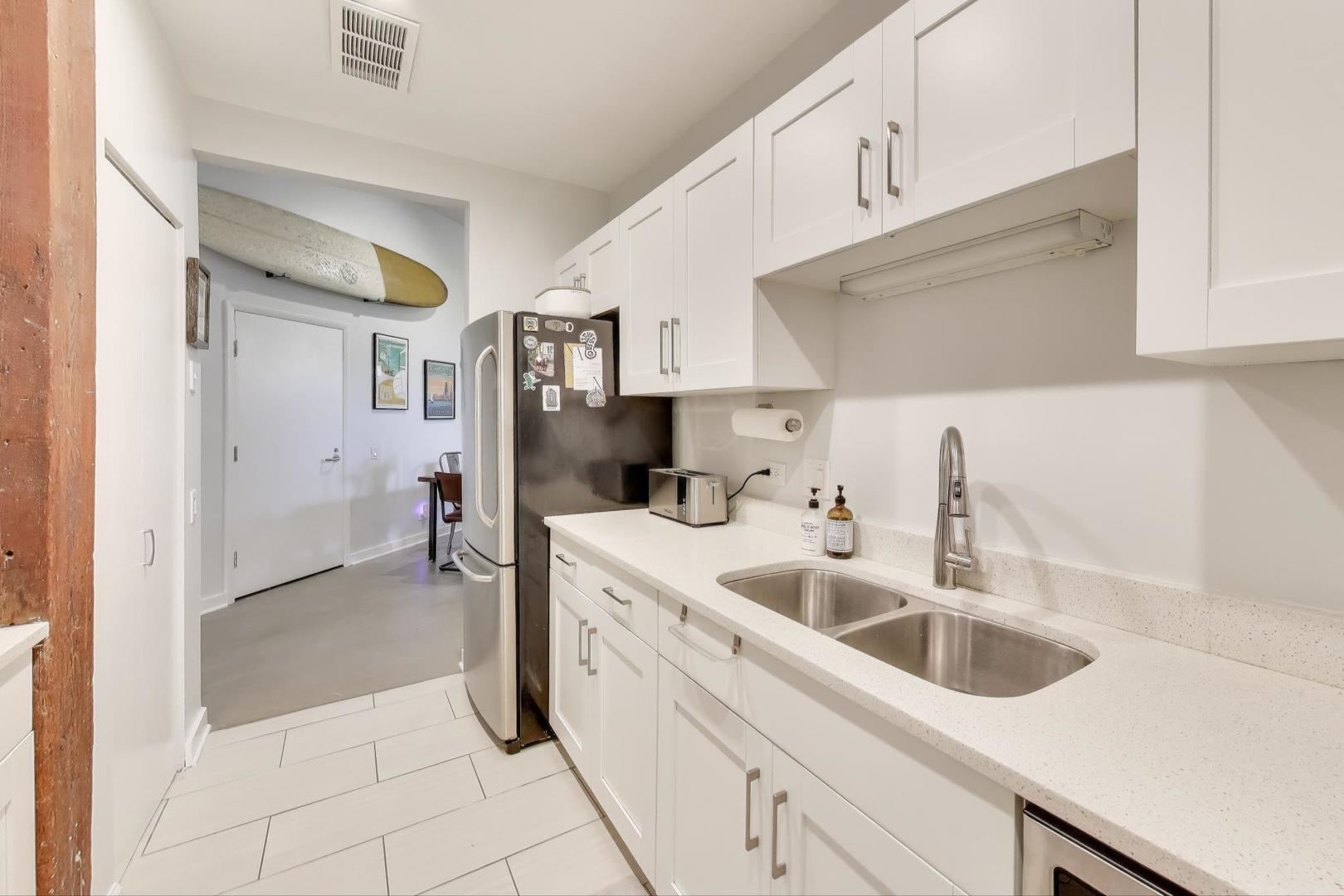 1323 West Belden Avenue, Unit E1 Chicago, IL 60614 - Photo 7 of 23 a kitchen with a sink cabinets and utility
