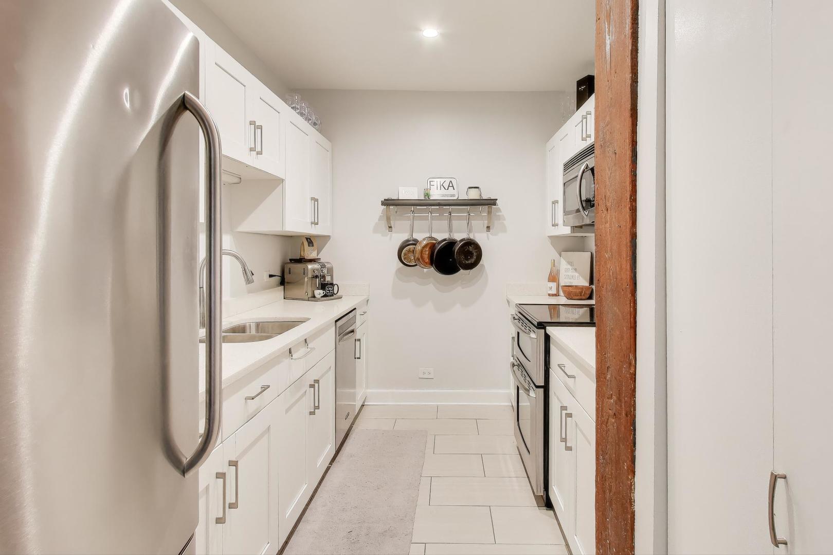 1323 West Belden Avenue, Unit E1 Chicago, IL 60614 - Photo 9 of 23 a bathroom with a double vanity sink and mirror
