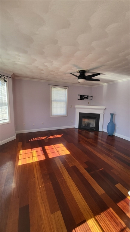 129 Manchester Street, Unit B Lowell, MA 01852 - Photo 15 of 26 wooden floor in an empty room with a fireplace