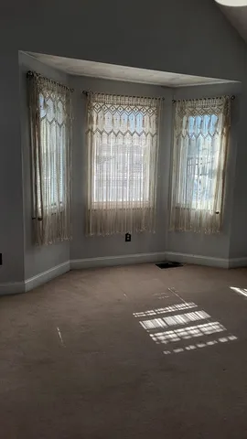 an empty room with windows and windows