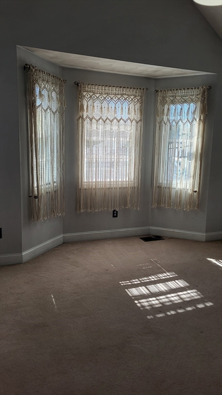 129 Manchester Street, Unit B Lowell, MA 01852 - Photo 16 of 26 an empty room with windows and windows
