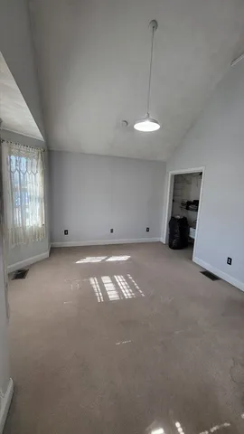 an empty room with windows and closet