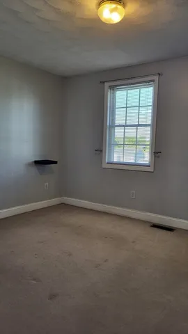 an empty room with a empty space and a window