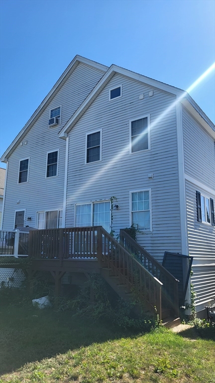 129 Manchester Street, Unit B Lowell, MA 01852 - Photo 2 of 26 a front view of a house with garden