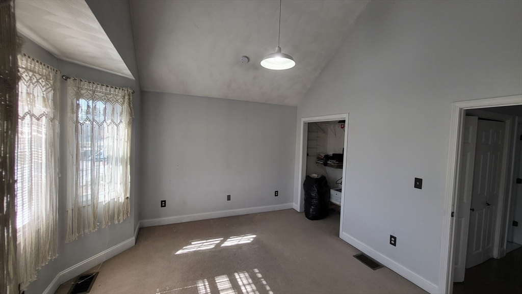 129 Manchester Street, Unit B Lowell, MA 01852 - Photo 23 of 26 an empty room with windows
