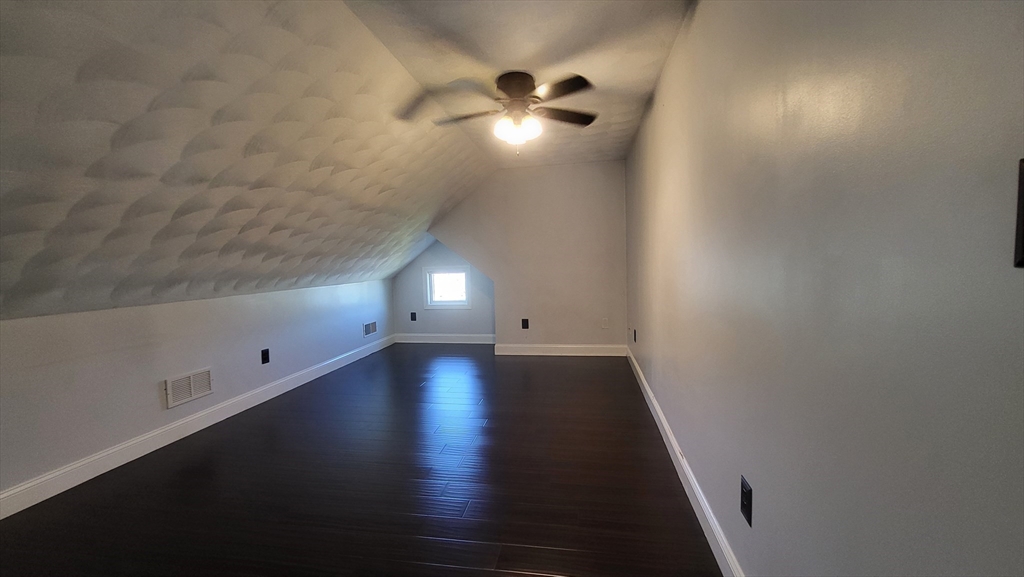 129 Manchester Street, Unit B Lowell, MA 01852 - Photo 25 of 26 an empty room with wooden floor and windows