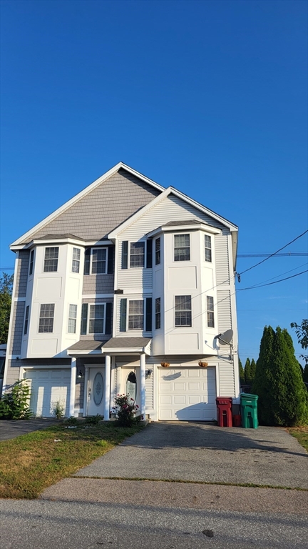 129 Manchester Street, Unit B Lowell, MA 01852 - Photo 3 of 26 a front view of a building with street