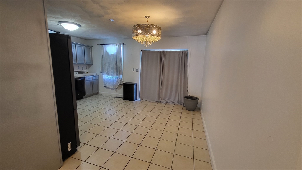 129 Manchester Street, Unit B Lowell, MA 01852 - Photo 7 of 26 a view of an empty room with a bathroom