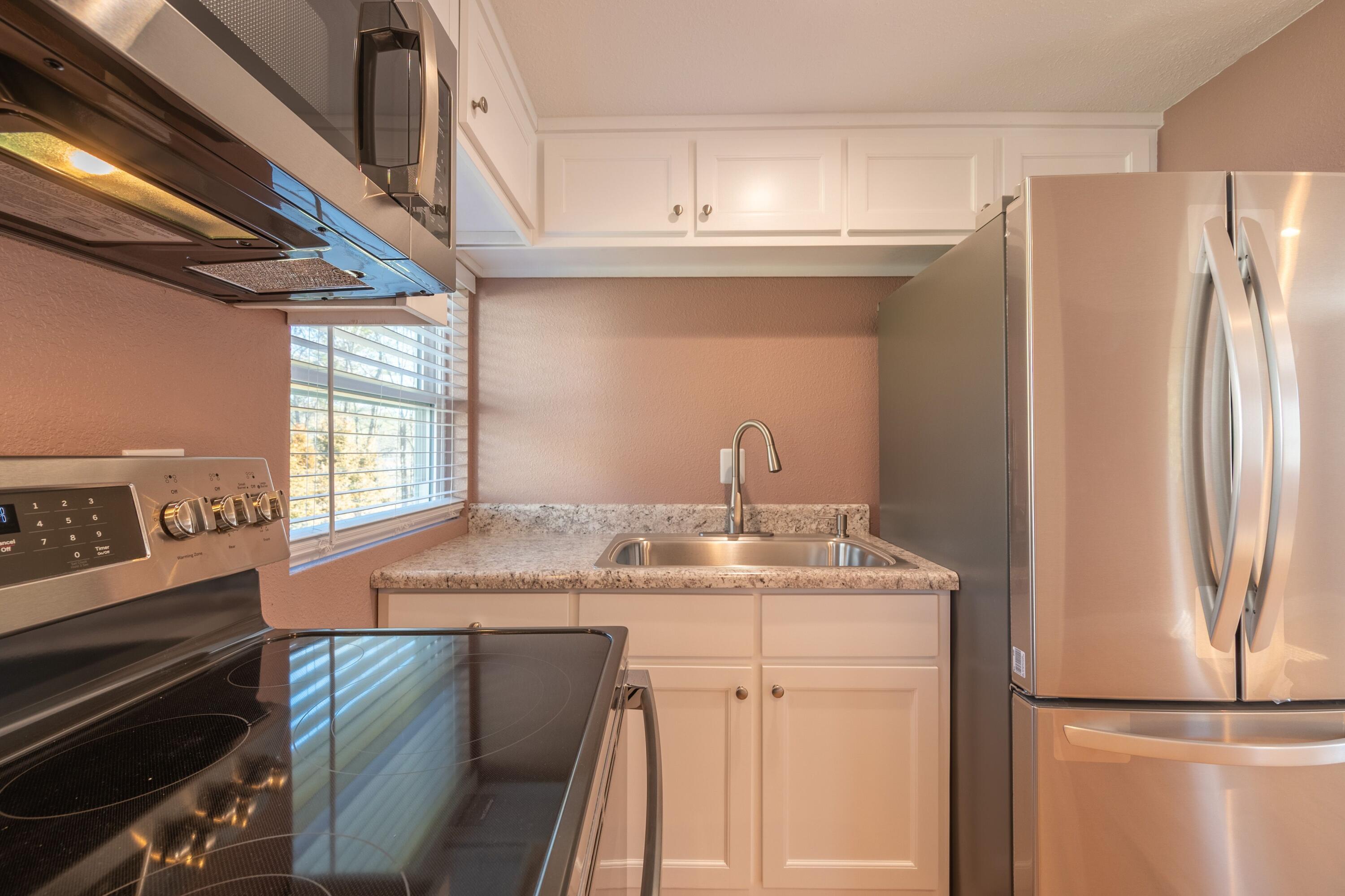 225 Mill Run Road Southwest Floyd, VA 24091 - Photo 16 of 46 a kitchen with stainless steel appliances granite countertop a refrigerator and a stove