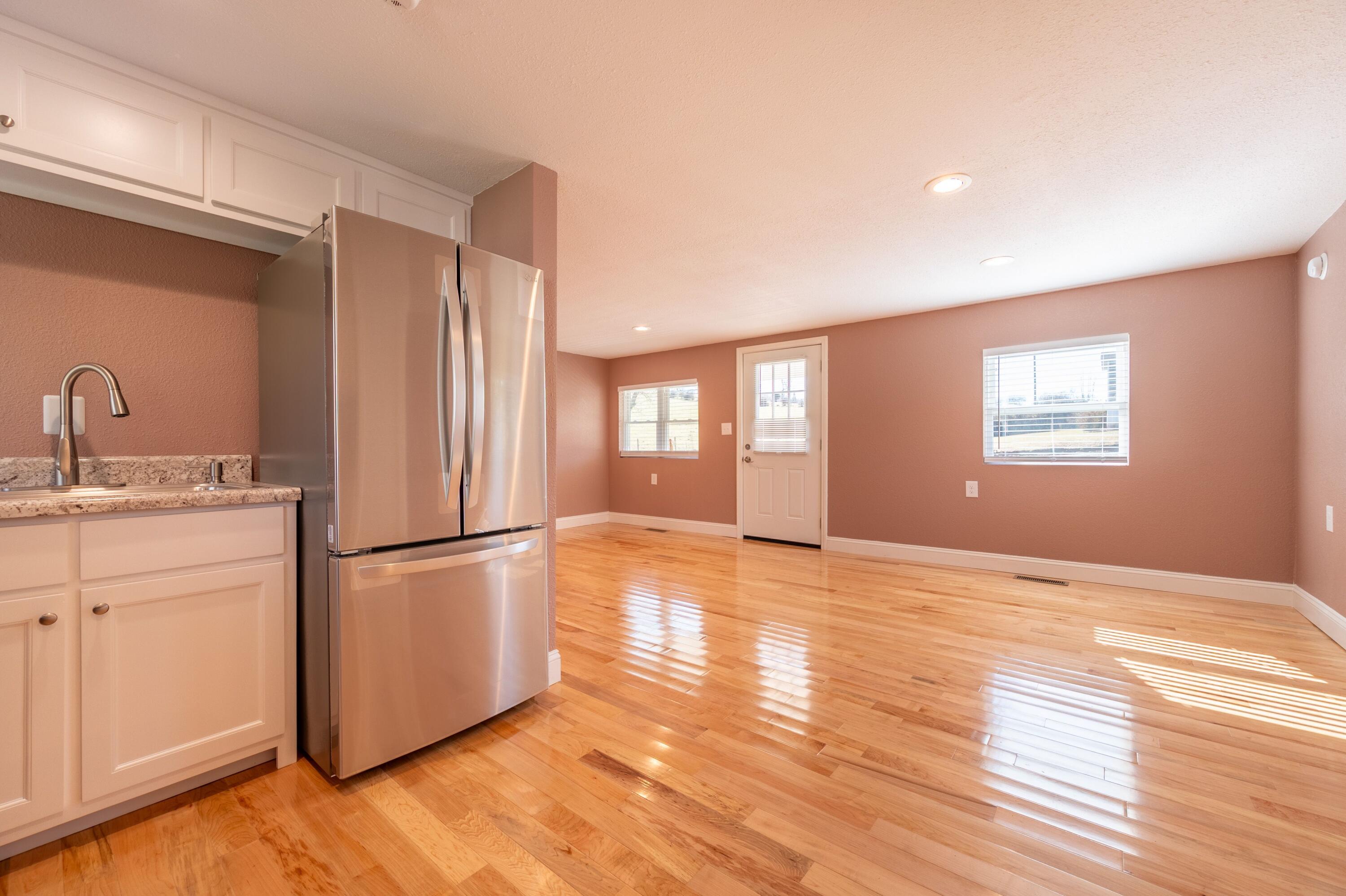225 Mill Run Road Southwest Floyd, VA 24091 - Photo 22 of 46 a view of a kitchen with a fridge wooden floor and a window