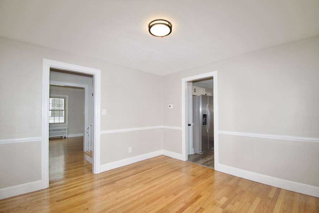 153 Gillette Avenue Springfield, MA 01118 - Photo 12 of 32 a view of an empty room with wooden floor and window