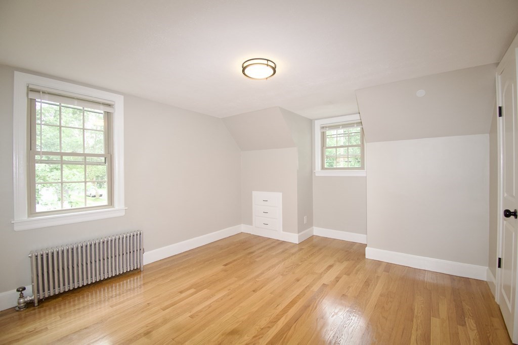 153 Gillette Avenue Springfield, MA 01118 - Photo 15 of 32 a view of an empty room with wooden floor and a window