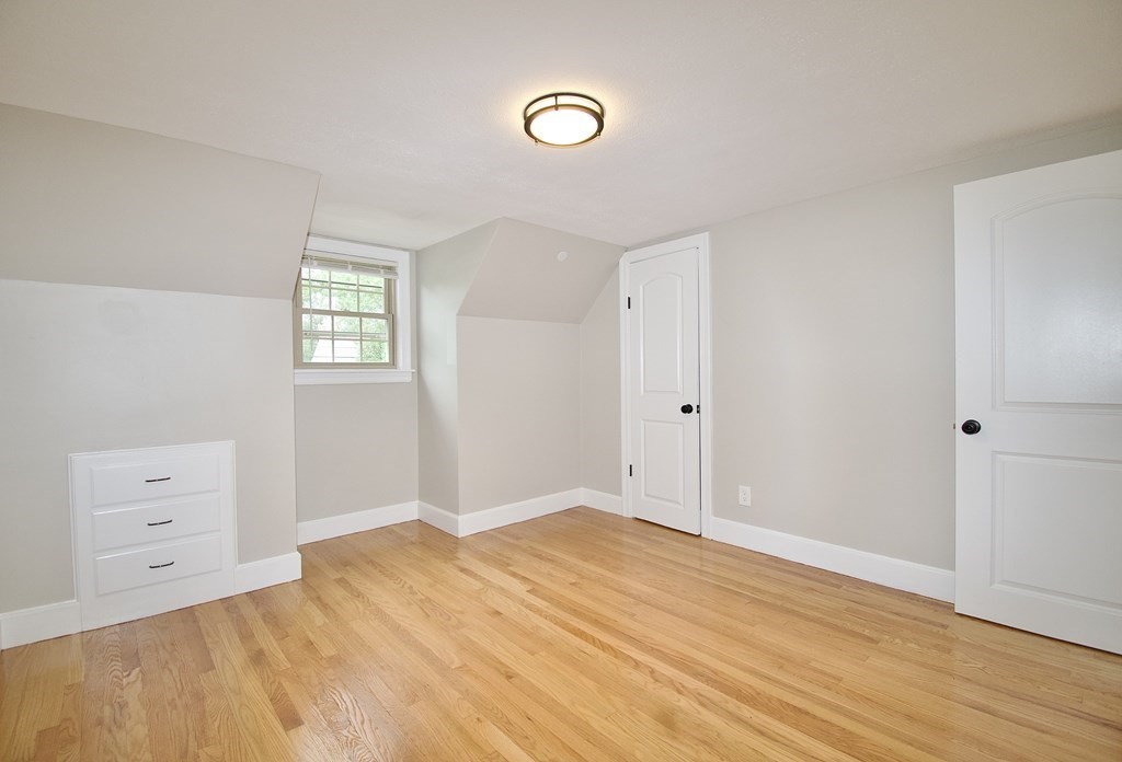 153 Gillette Avenue Springfield, MA 01118 - Photo 16 of 32 a view of empty room with window and wooden floor