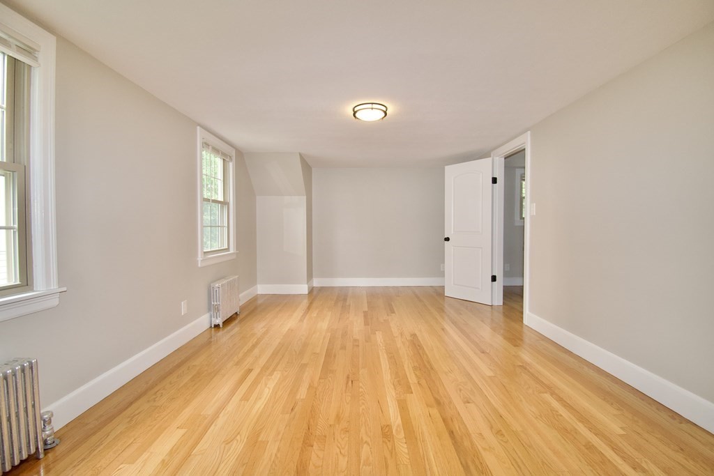 153 Gillette Avenue Springfield, MA 01118 - Photo 21 of 32 a view of empty room with wooden floor and fan
