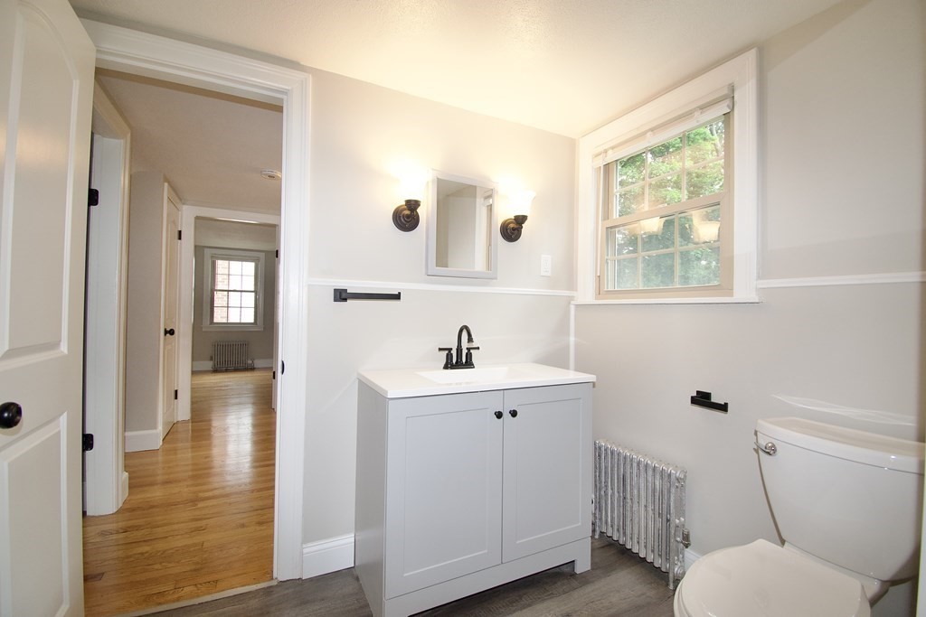 153 Gillette Avenue Springfield, MA 01118 - Photo 22 of 32 a bathroom with a sink a toilet and a window