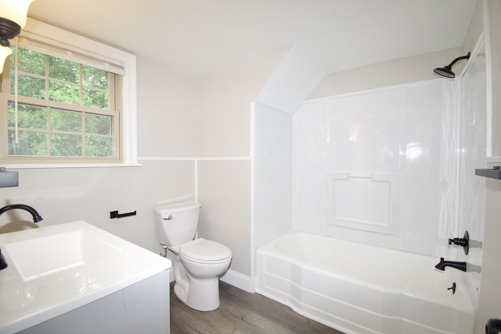 153 Gillette Avenue Springfield, MA 01118 - Photo 23 of 32 a bath room with a toilet a sink and a bath tub