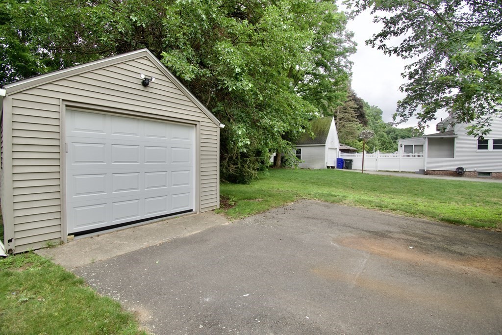 153 Gillette Avenue Springfield, MA 01118 - Photo 29 of 32 a front view of a house with a yard and garage