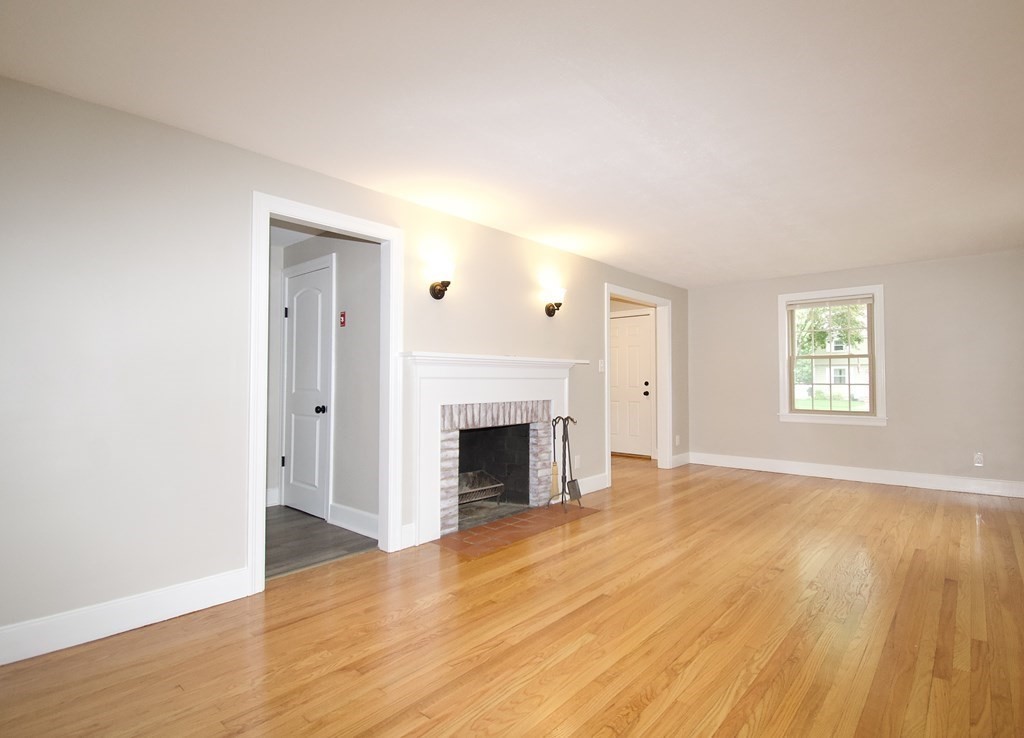 153 Gillette Avenue Springfield, MA 01118 - Photo 4 of 32 wooden floor fireplace and natural light in room