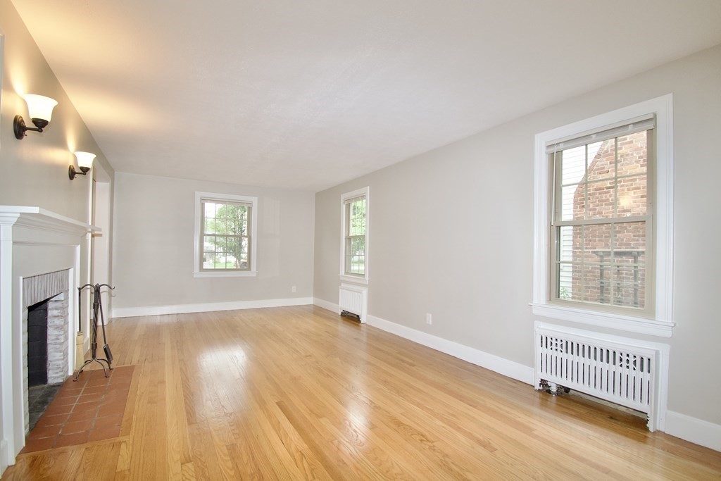 153 Gillette Avenue Springfield, MA 01118 - Photo 5 of 32 an empty room with windows and fireplace
