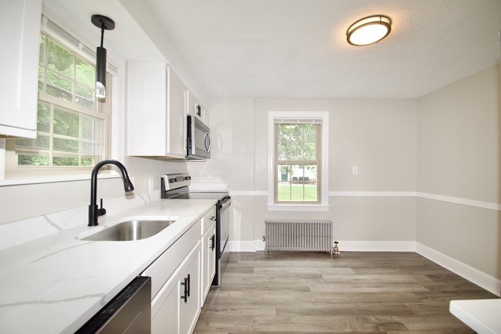 153 Gillette Avenue Springfield, MA 01118 - Photo 10 of 32 a kitchen with a sink a window and cabinets