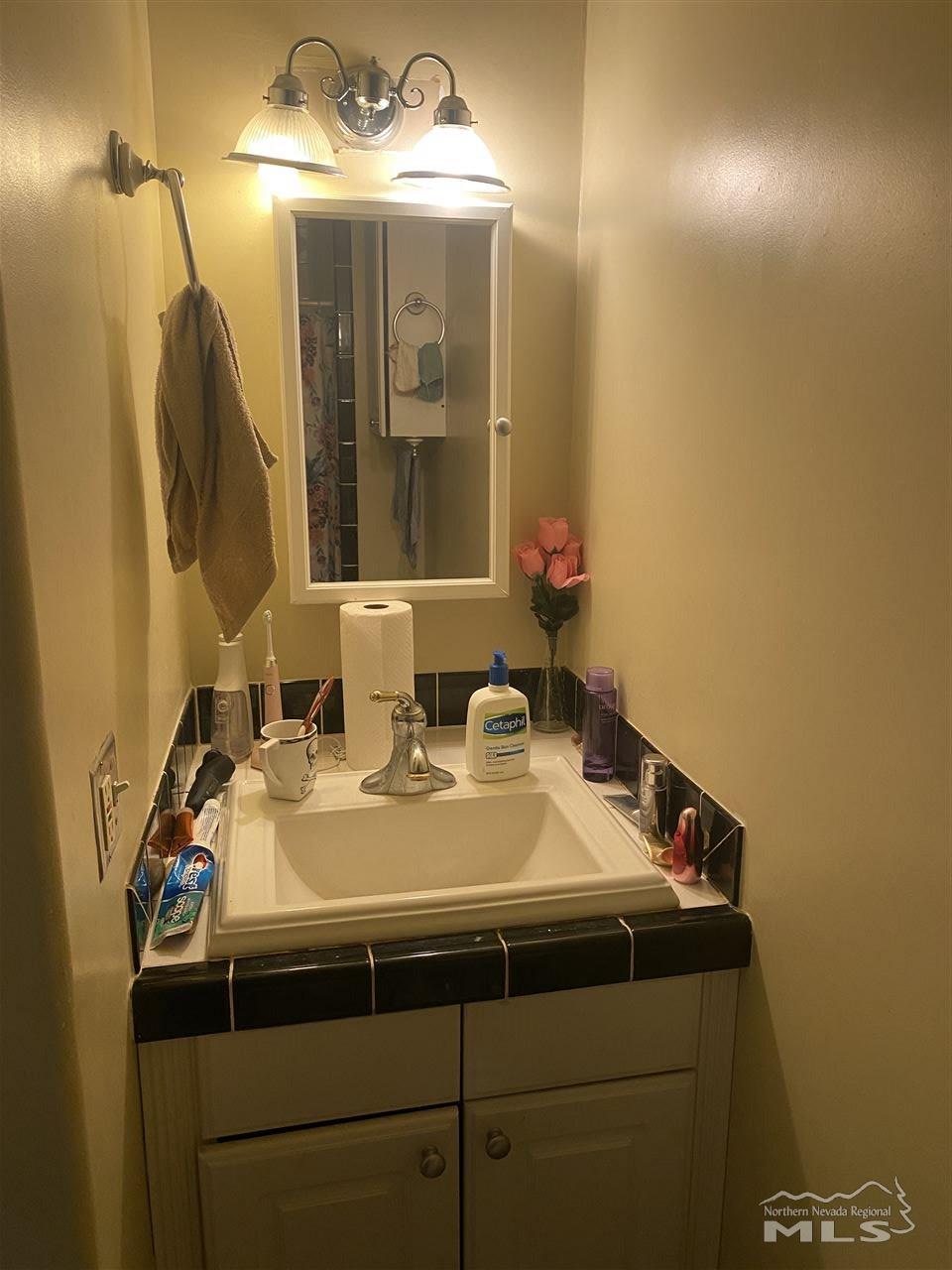 53 West 9th Street Reno, NV 89503 - Photo 14 of 33 a bathroom with a sink and a mirror