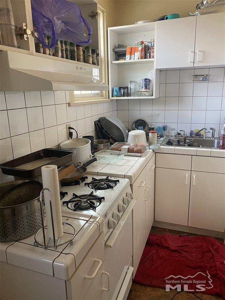 53 West 9th Street Reno, NV 89503 - Photo 21 of 33 a kitchen with a stove and cabinets