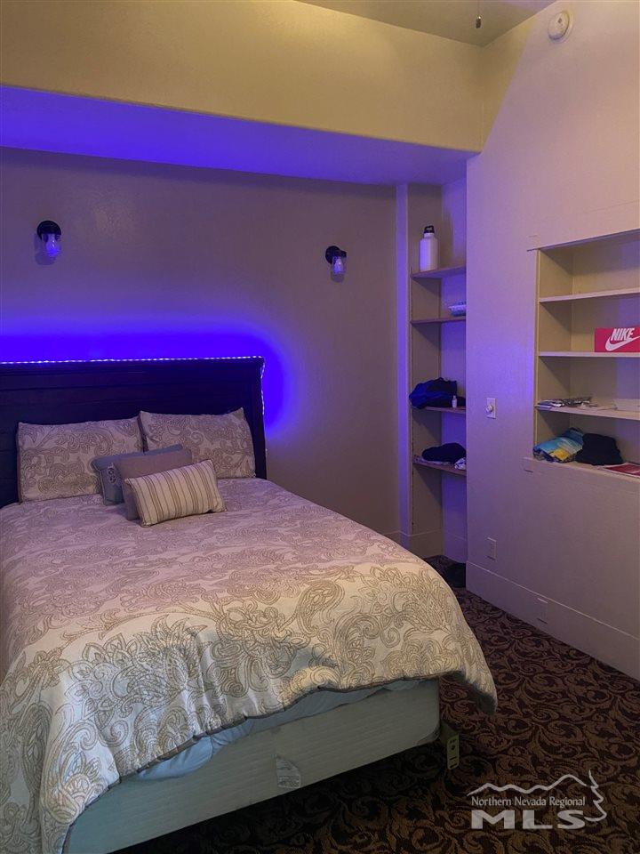 53 West 9th Street Reno, NV 89503 - Photo 24 of 33 a large bed sitting in a bedroom next to a window
