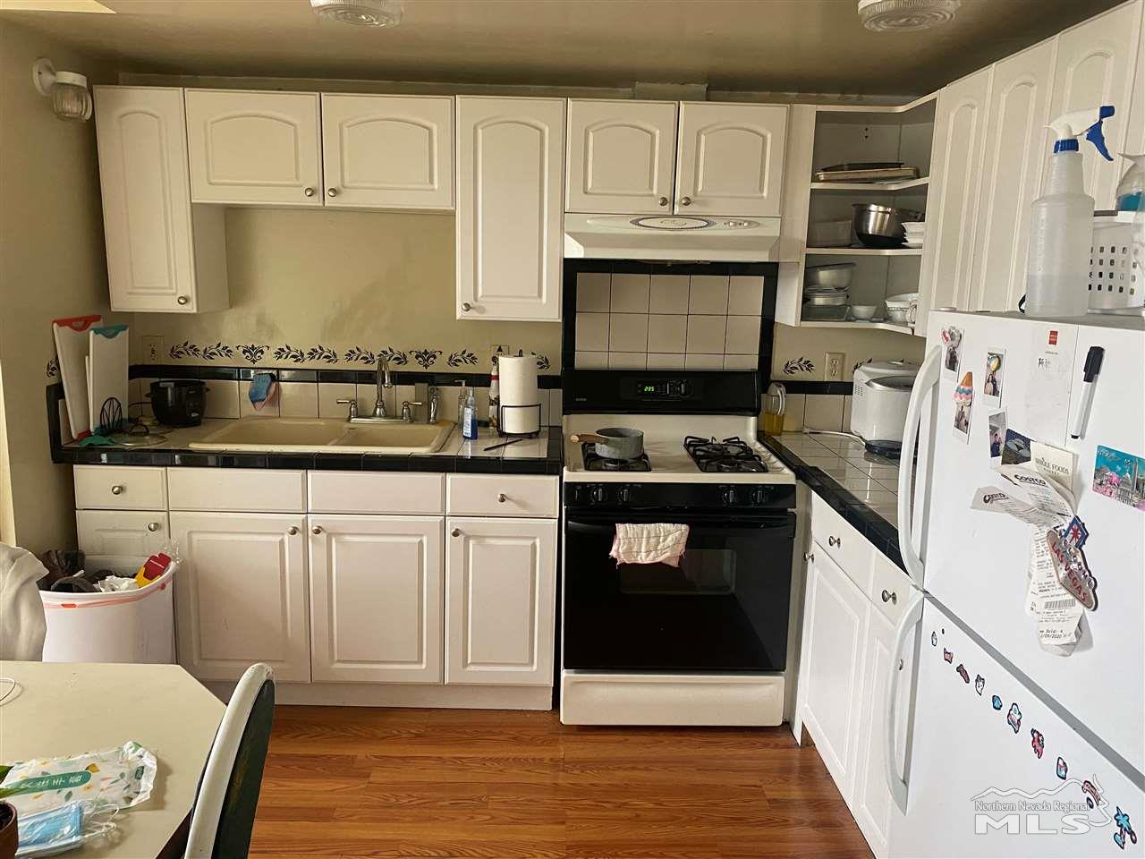 53 West 9th Street Reno, NV 89503 - Photo 27 of 33 a kitchen with stainless steel appliances granite countertop a stove a sink and a refrigerator