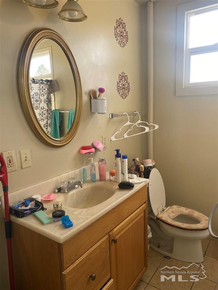 53 West 9th Street Reno, NV 89503 - Photo 29 of 33 a bathroom with a toilet a sink and a mirror