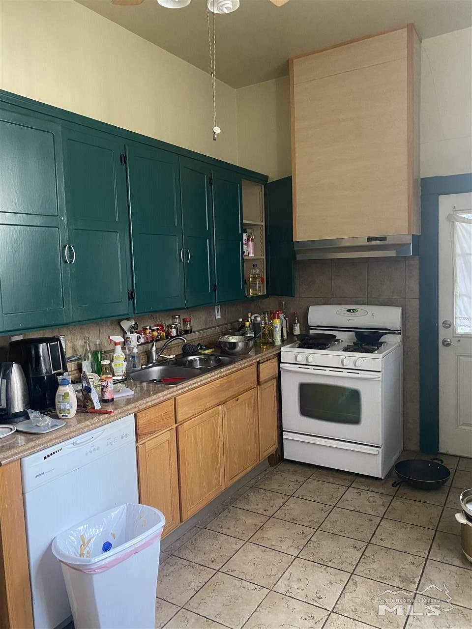 53 West 9th Street Reno, NV 89503 - Photo 7 of 33 a kitchen with a sink stove and cabinets