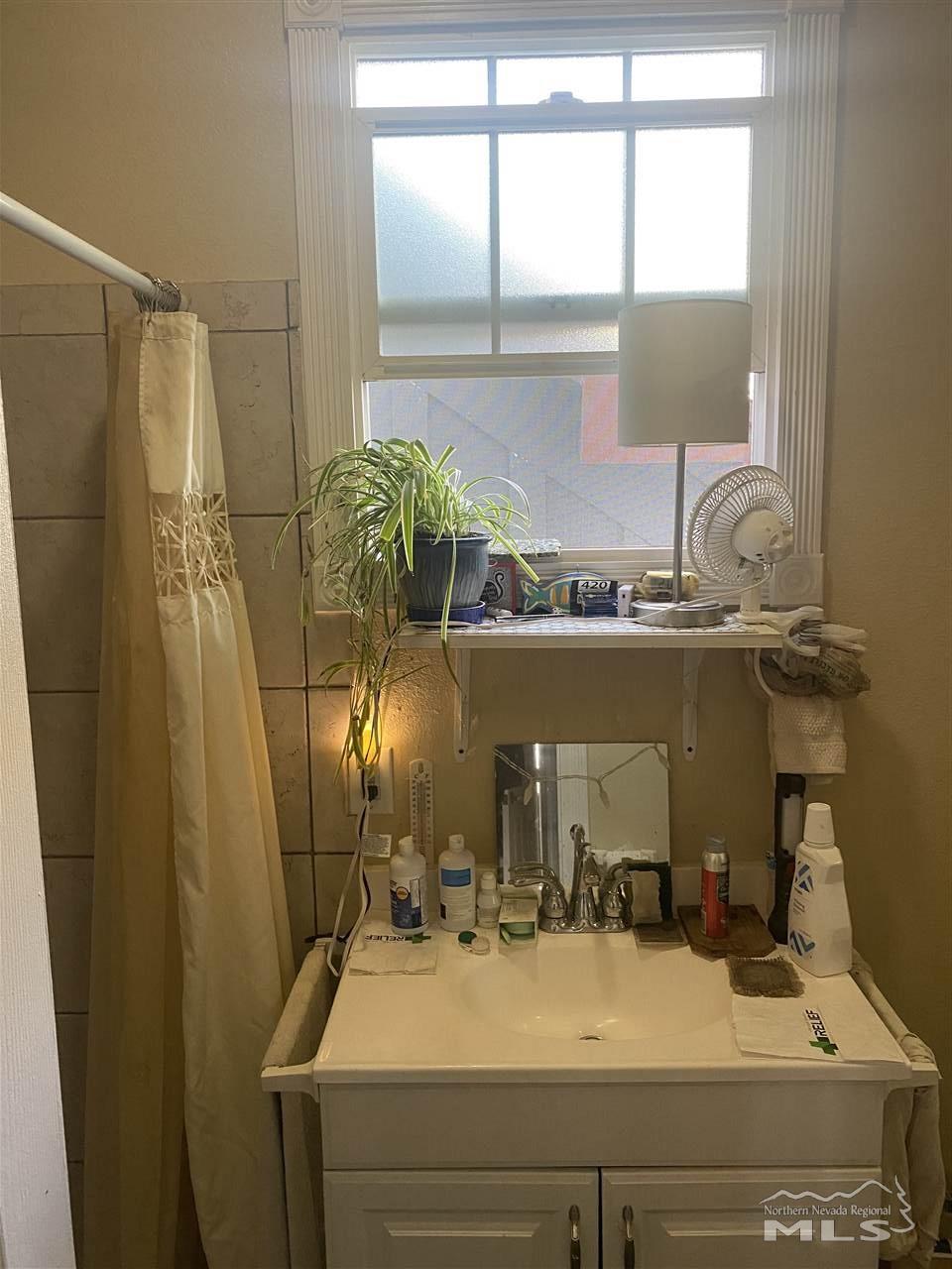 53 West 9th Street Reno, NV 89503 - Photo 9 of 33 a bathroom with a sink and a mirror
