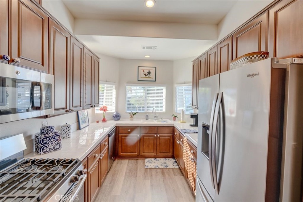 1526 South Fulton Court Santa Maria, CA 93458 - Photo 11 of 39 a kitchen with stainless steel appliances granite countertop a refrigerator and a stove