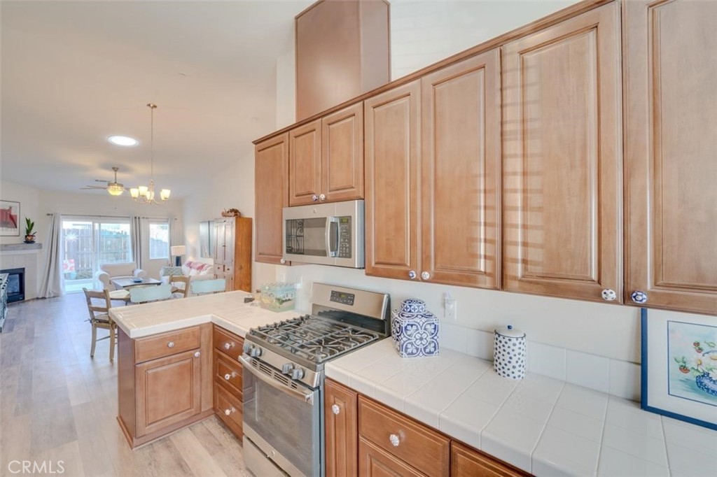 1526 South Fulton Court Santa Maria, CA 93458 - Photo 13 of 39 a kitchen with a sink stove and cabinets