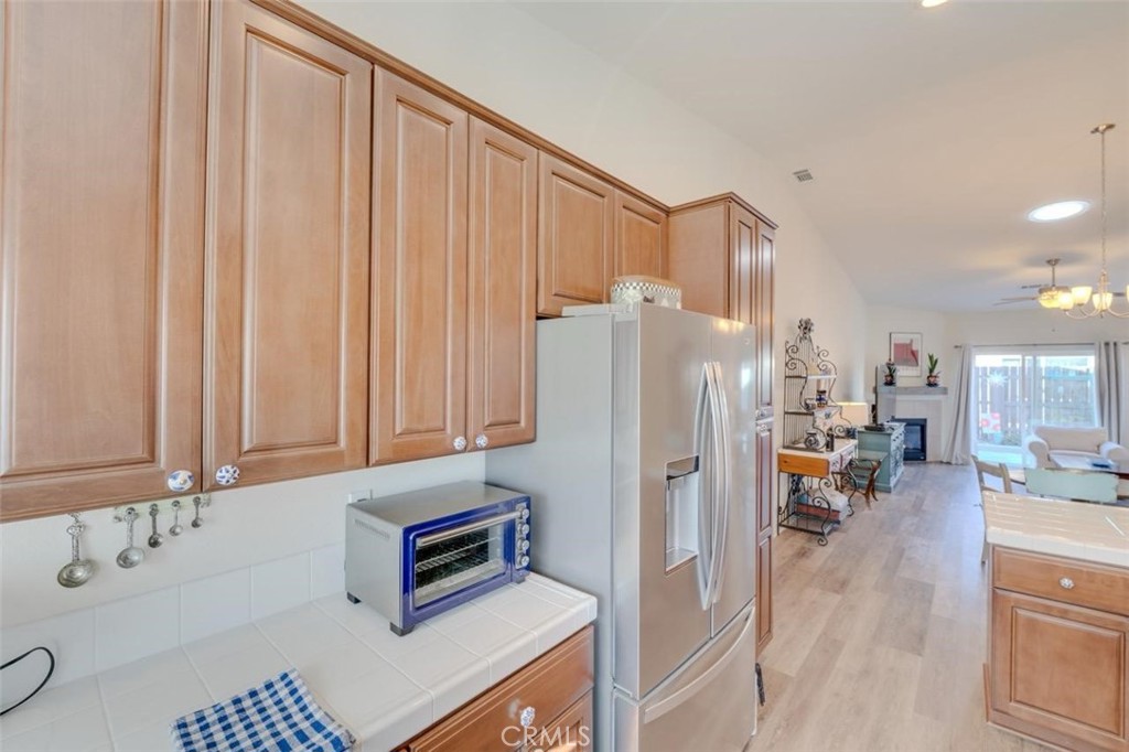 1526 South Fulton Court Santa Maria, CA 93458 - Photo 15 of 39 a kitchen with refrigerator and cabinets