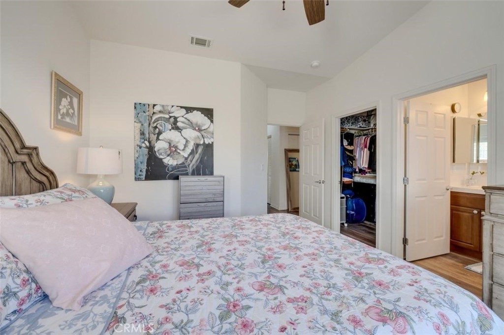 1526 South Fulton Court Santa Maria, CA 93458 - Photo 20 of 39 a bedroom with a large bed and a chandelier