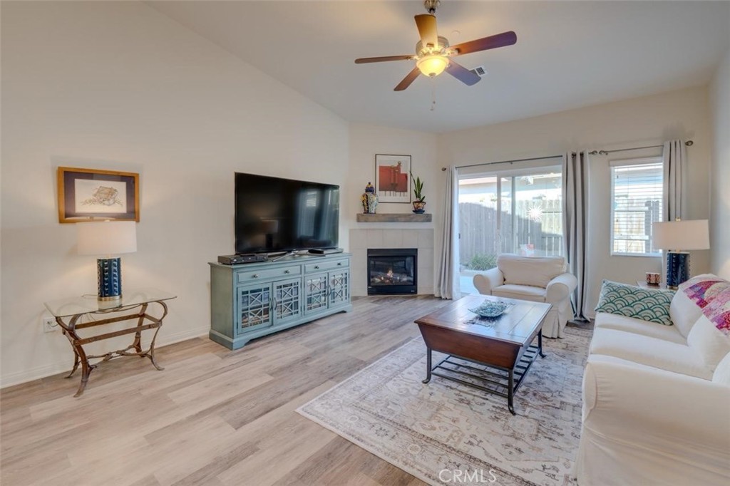 1526 South Fulton Court Santa Maria, CA 93458 - Photo 2 of 39 a living room with furniture a flat screen tv and a fireplace