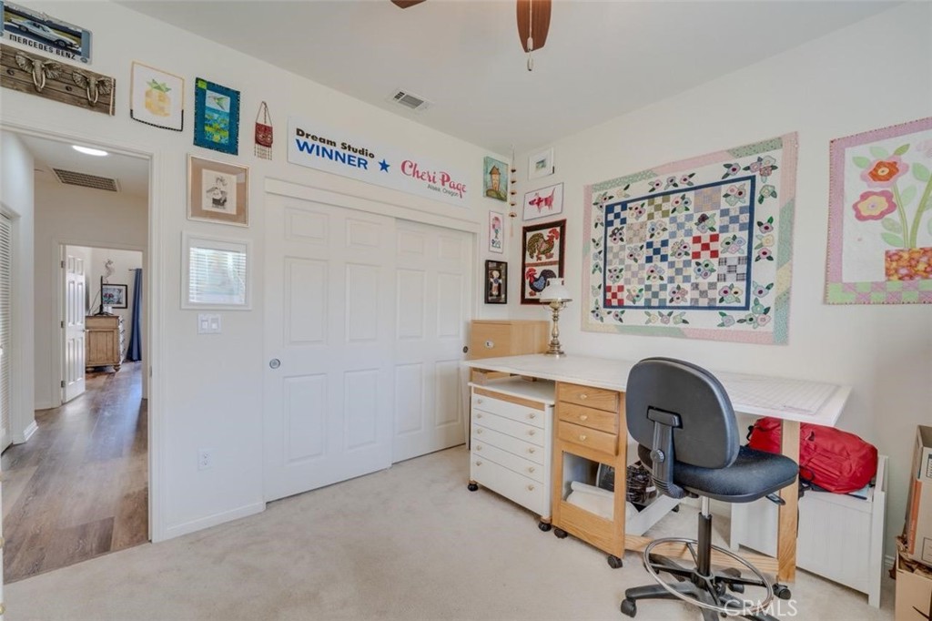 1526 South Fulton Court Santa Maria, CA 93458 - Photo 26 of 39 a view of a workspace with furniture and a fan