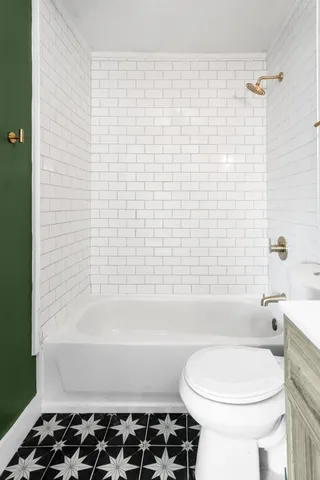 a bathroom with a bathtub and a toilet