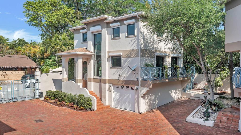 3263 Allamanda Street, Unit 3263 Miami, FL 33133 - Photo 1 of 28 a front view of a house with garden
