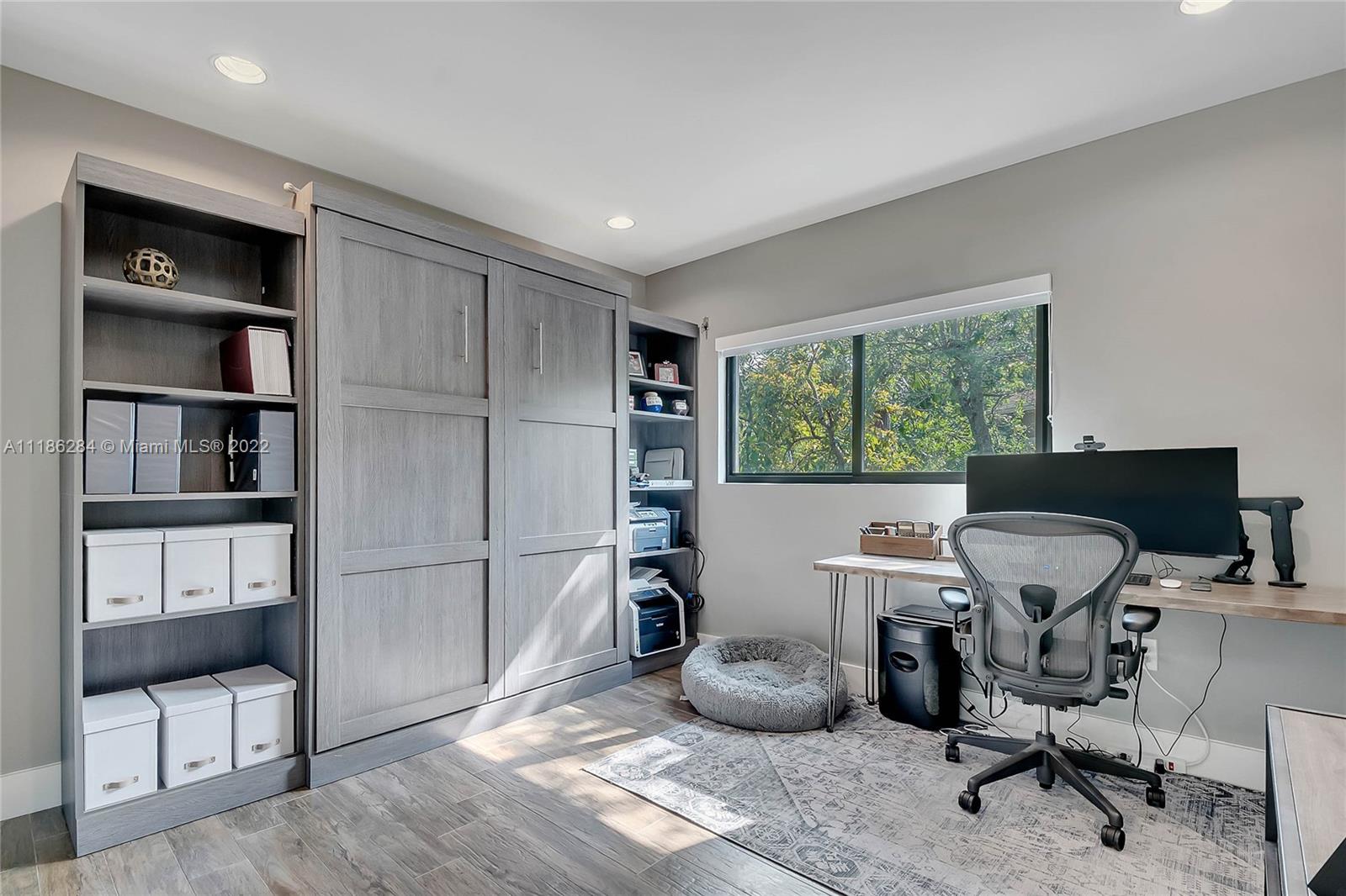 3263 Allamanda Street, Unit 3263 Miami, FL 33133 - Photo 13 of 28 a view of a workspace with furniture and a window
