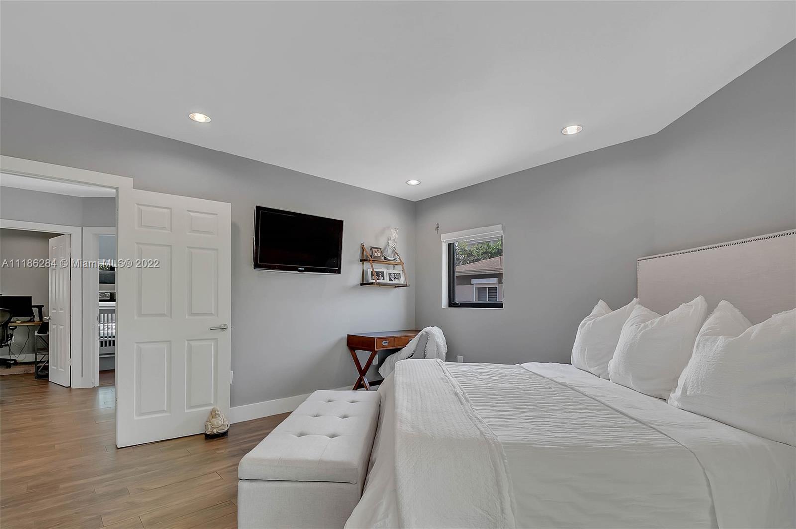 3263 Allamanda Street, Unit 3263 Miami, FL 33133 - Photo 18 of 28 a bedroom with a bed and a flat screen tv