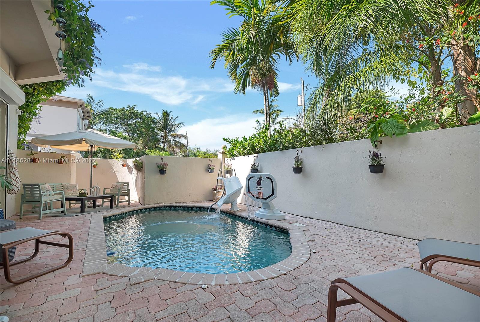 3263 Allamanda Street, Unit 3263 Miami, FL 33133 - Photo 21 of 28 an aerial view of a house with swimming pool and wooden fence