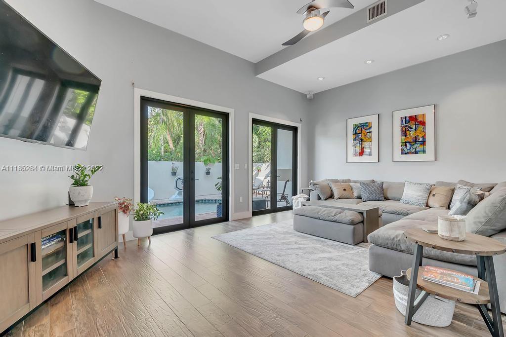 3263 Allamanda Street, Unit 3263 Miami, FL 33133 - Photo 3 of 28 a living room with furniture and a flat screen tv