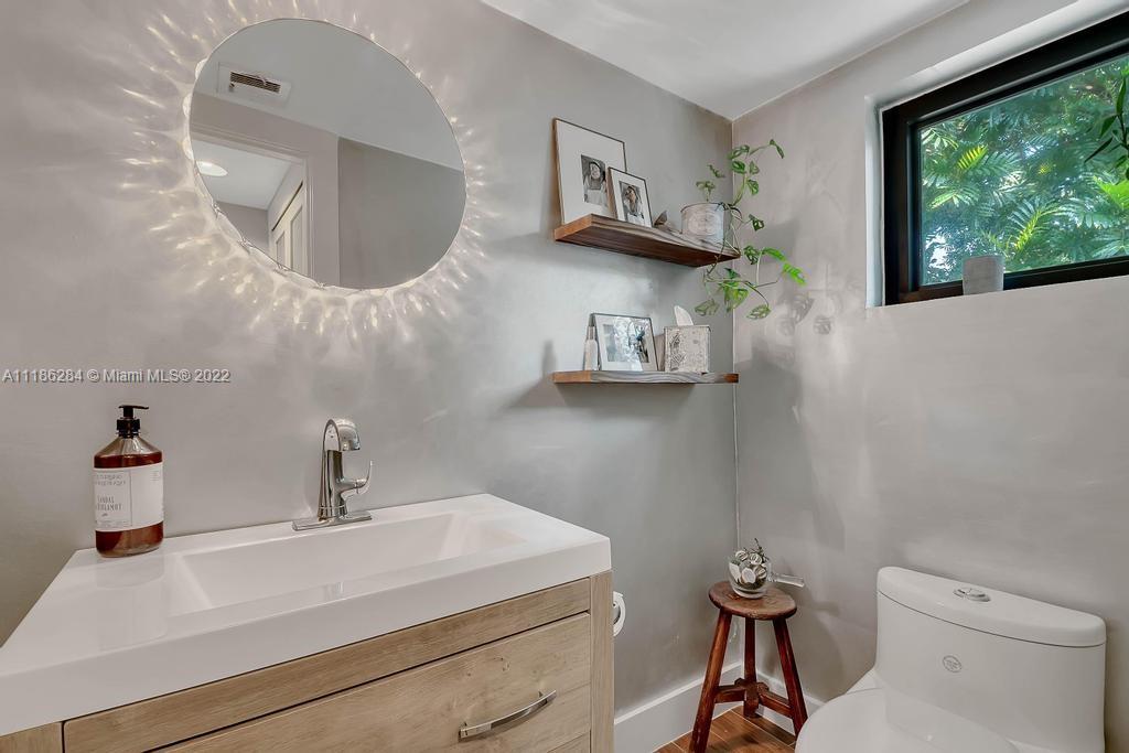 3263 Allamanda Street, Unit 3263 Miami, FL 33133 - Photo 5 of 28 a bathroom with a sink and a mirror