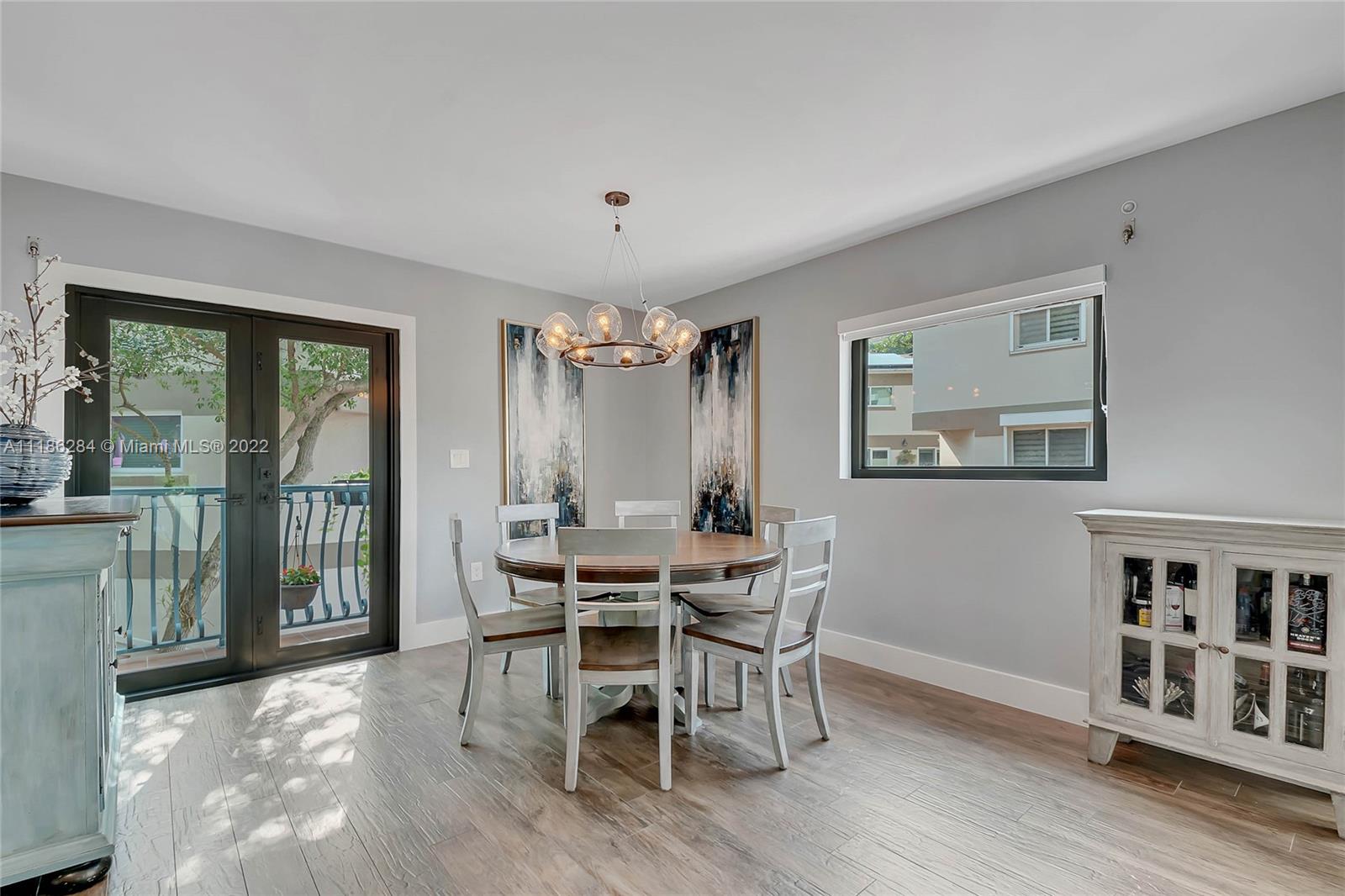 3263 Allamanda Street, Unit 3263 Miami, FL 33133 - Photo 6 of 28 a view of a dining room with furniture and window