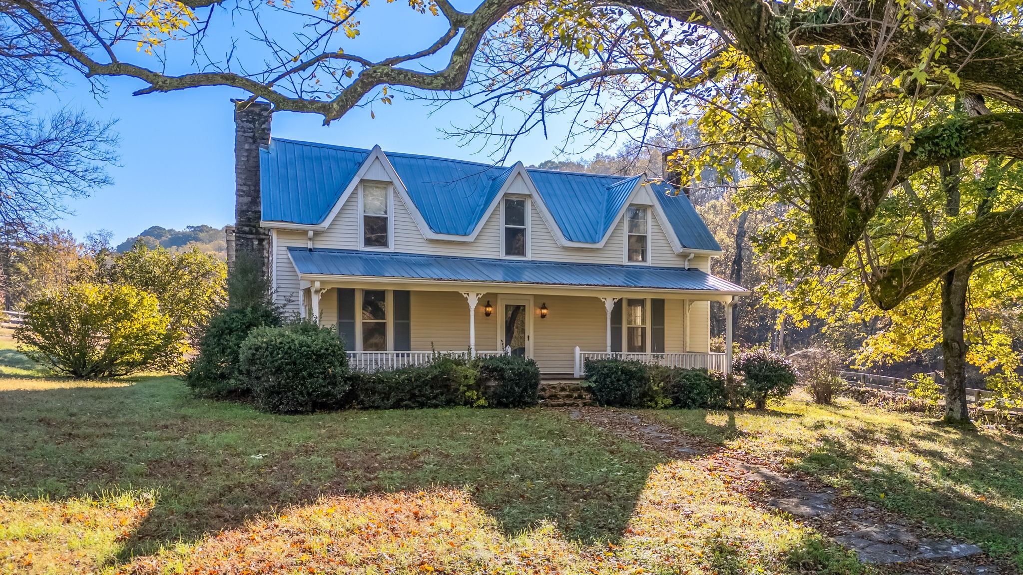 a front view of house with yard and green space