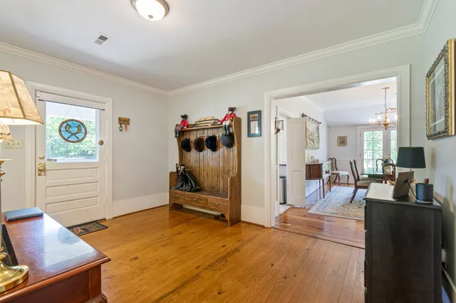 a view of a a dining room with furniture window and wooden floor